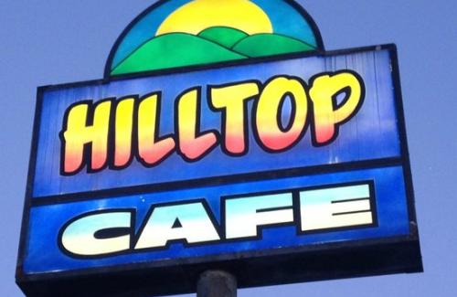 Hilltop Cafe Sign against blue sky