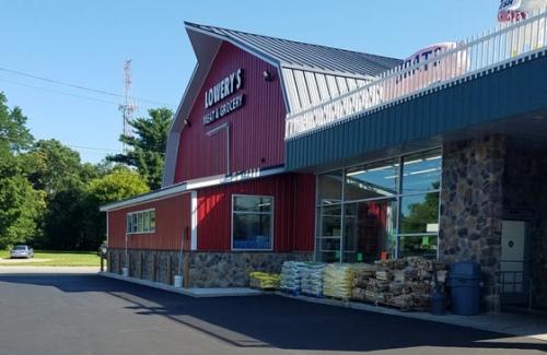 Exterior of a red barn style grocery store
