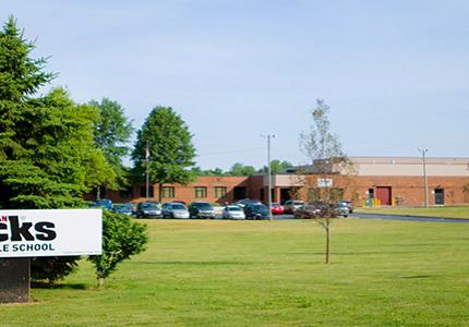 single story modern brick building with Buchanan Middle School sign outside
