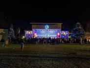 blue bandshell decorated for the holidays in colored lights