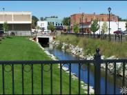 creek bordered by rocks alongside downtown