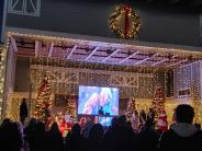 Christmas lights on the commons with people on stage