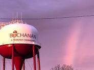 Up close photo of the water tower with a purplish pink sky 