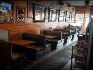 Interior of family pub style restaurant featuring booths and a bar