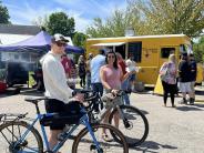 people on bikes eating at food truck