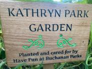 Wooden sign with green text that says Kathryn Park Garden