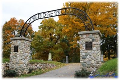 Wrought iron archway on stone foundation that says Oakridge Cemetary