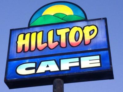 Hilltop Cafe Sign against blue sky