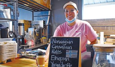 Smiling woman behind counter of cafe