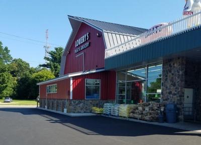 Exterior of a red barn style grocery store