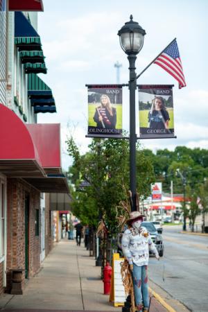 Downtown Buchanan MI, black lightpost with two banners showing high school band members