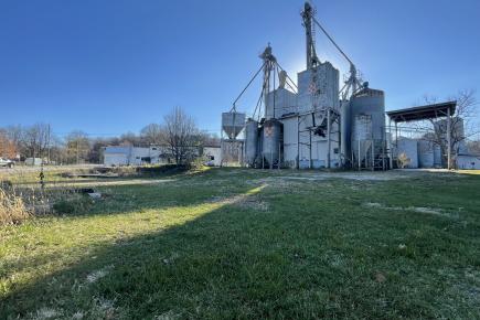 view of feed mill on large green lawn